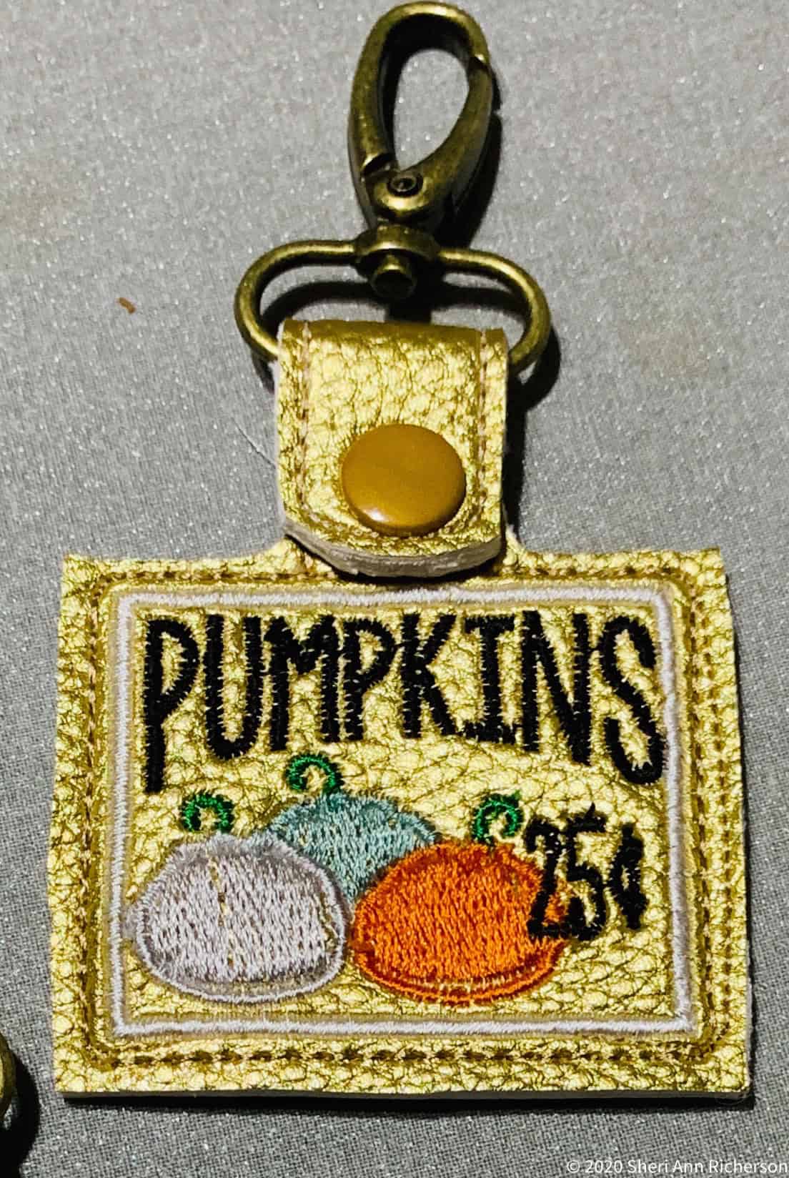 Vintage embroidered Pumpkins patch keychain with metal clasp for gardening or fall decor.