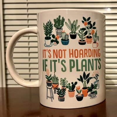 Green potted plant mug with plants and quote about indoor gardening.